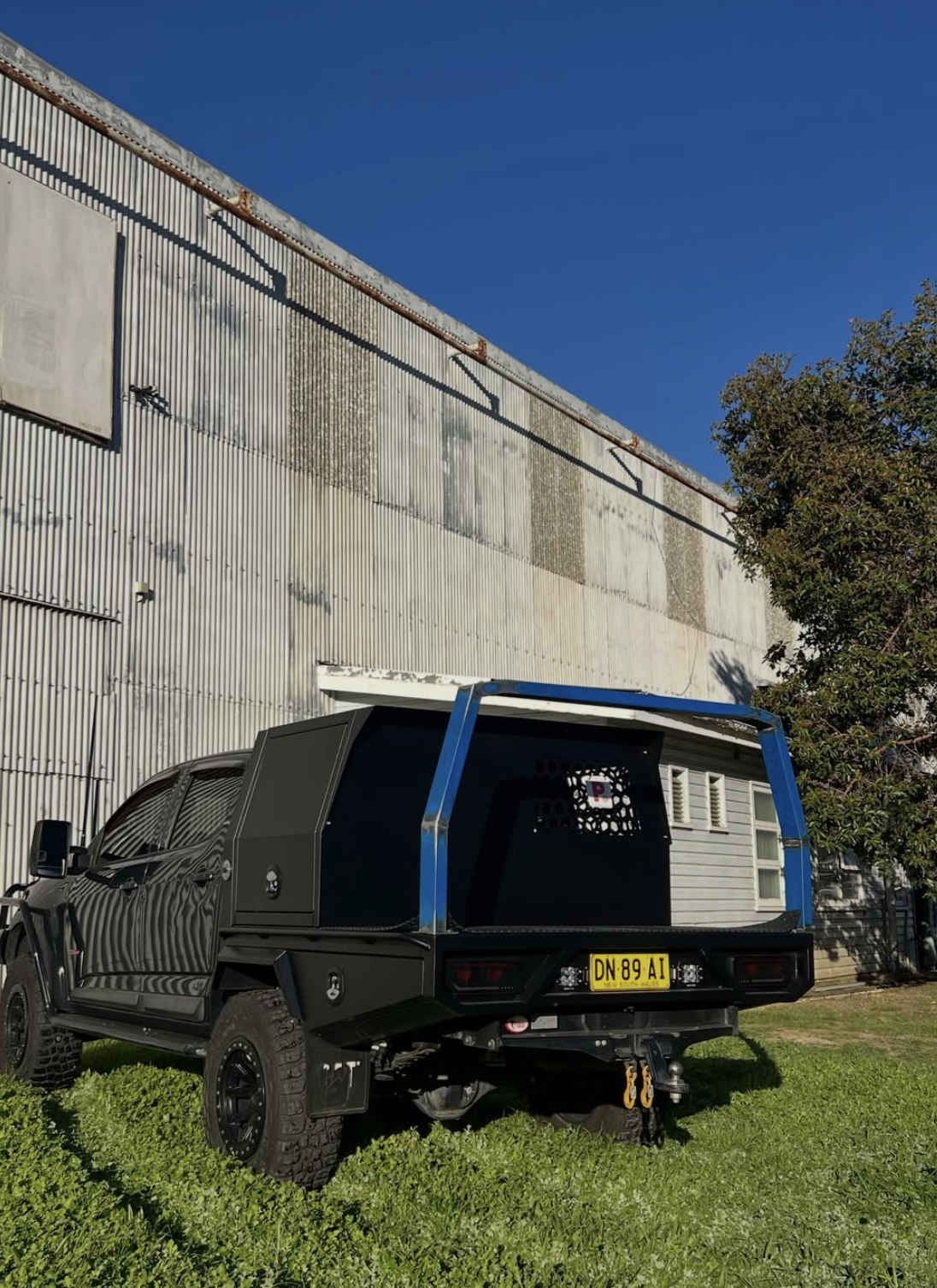 Custom matte black ute canopy with blue accents by KT Kustoms